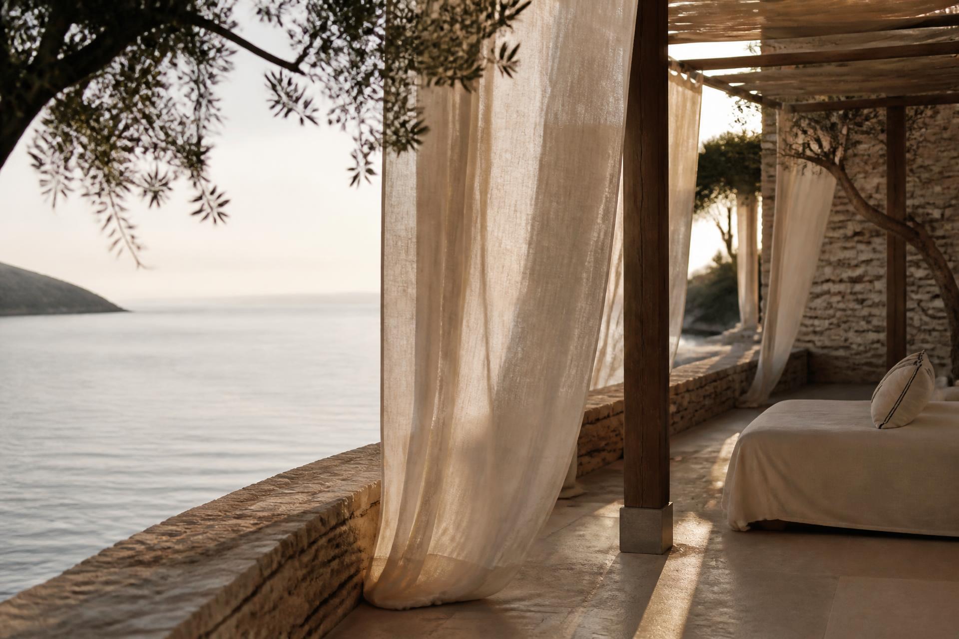 A quiet Mediterranean terrace at golden hour, linen curtains, view to the sea